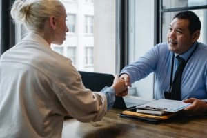 A job applicant shaking hands with a recruiter after an internship interview